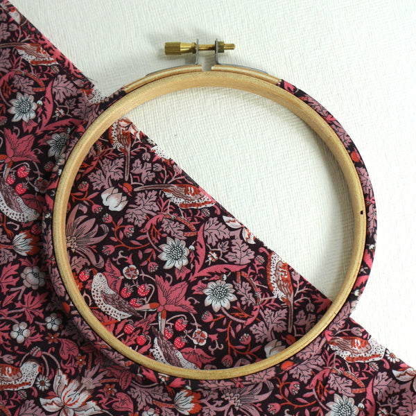 Embroidery hoop wrapped in Pink 'Strawberry Thief' fabric, 'Strawberry Thief' fabric was designed by William Morris, a name famous within the Arts and Crafts movement.