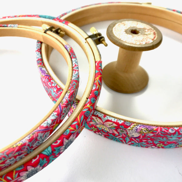 Red embroidery hoop frame, wrapped in 'Strawberry Thief' fabric. This hoop features the Iconic 'Strawberry Thief' fabric designed by William Morris, a name famous within the Arts and Crafts movement.