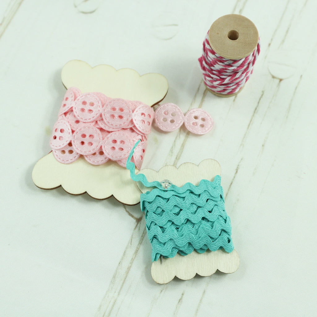 Pink Satin Button Ribbon and Turquoise Ric-Rac on a wooden Bobbin