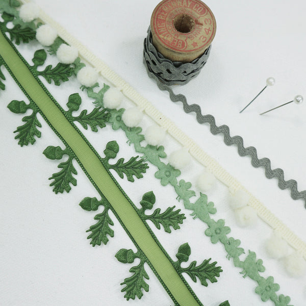 woodland ribbon collection. grey ric race. ivory Pom pom. sheer green oak leaf ribbon and a felt bit trim in sage green