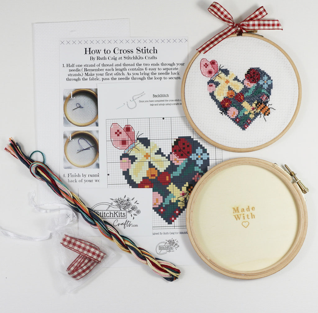 Cross stitch kit with tutorial, cross stitch charts, threads and hoop.