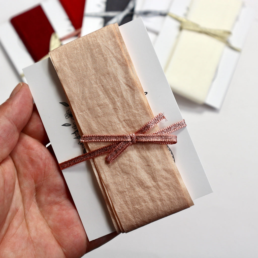 Wide champagne coloured faux silk ribbon.