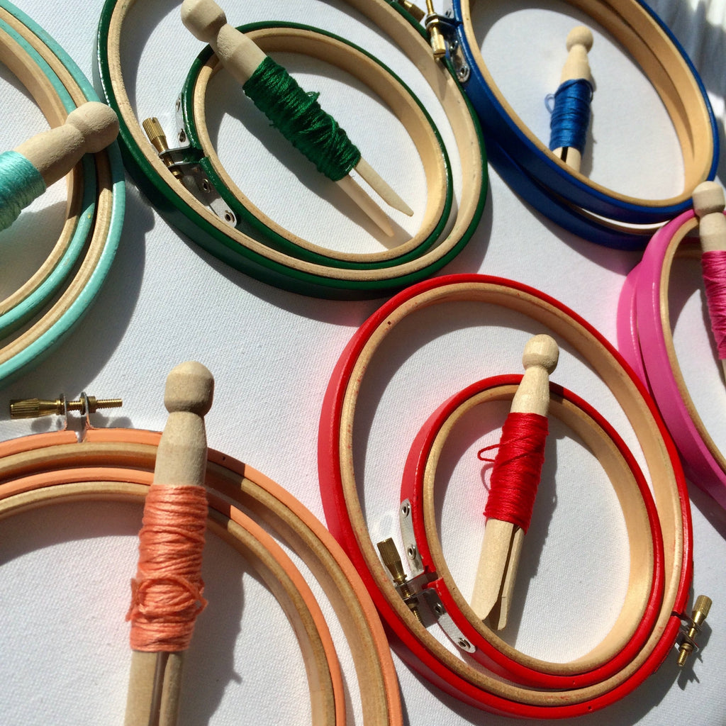 Coloud embroidery hoops with DMC threads on pegs