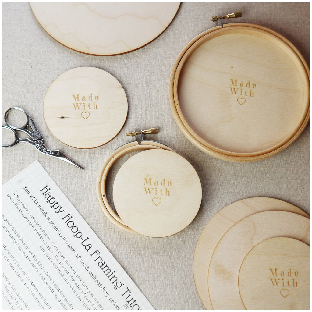 Wooden embroidery hoops with wooden backs and stork embroidery scissors.
