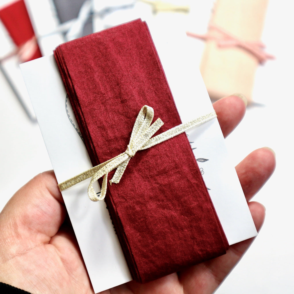 5 meters of dark red faux silk on a card.