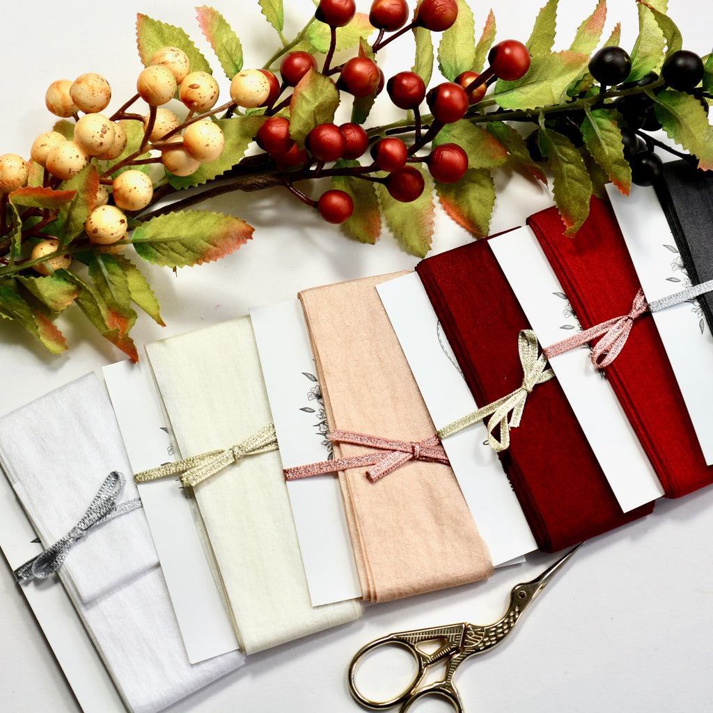 38 mm wide faux silk ribbon on cards in 7 different colours.