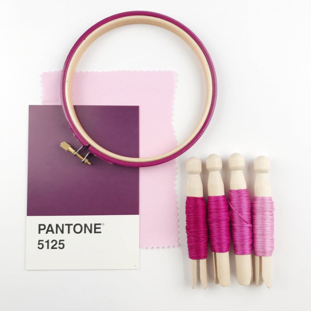 Dark pink-purple coloured embroidery hoop mood board.
