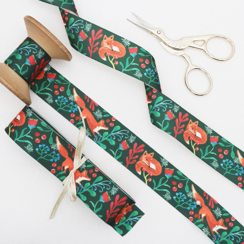 Hunter green wodland themed ribbon on a vintage cotton reel.