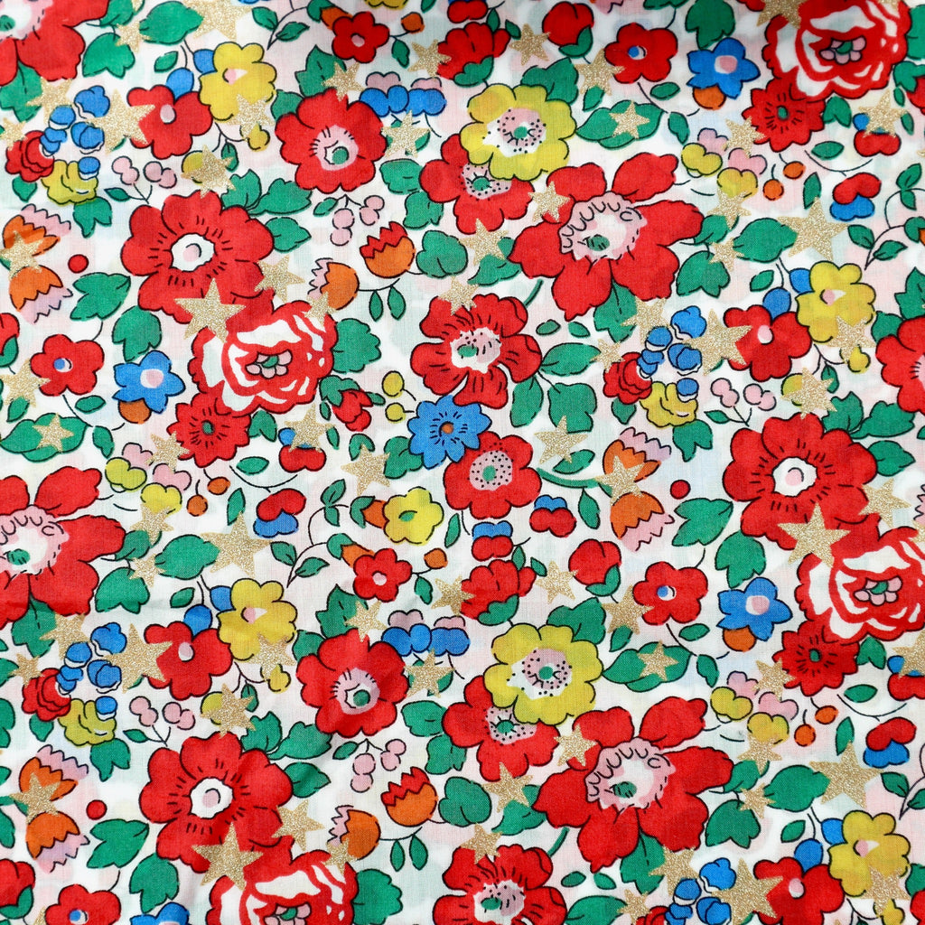 Betsy Star Tana Lawn fabric with metallic gold stars.