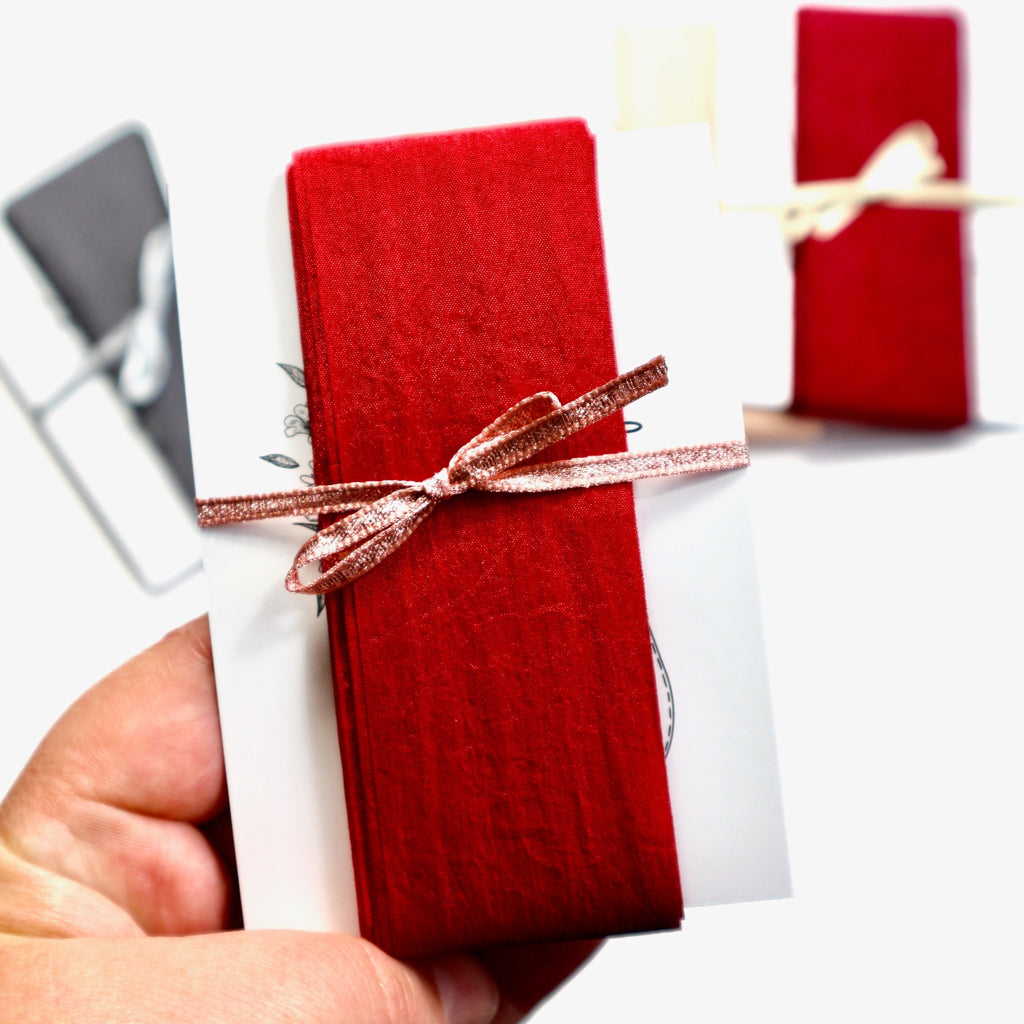 38mm wide red faux silk ribbon on a card.