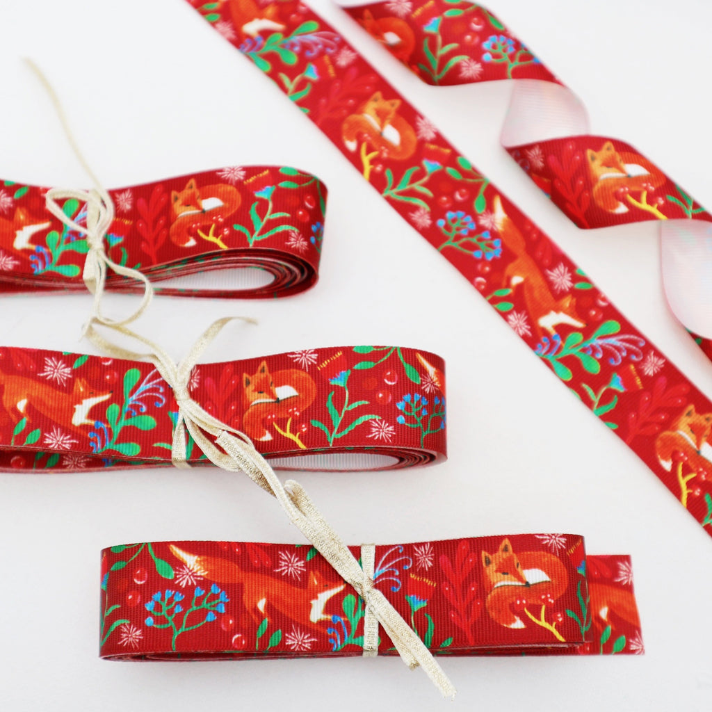 5 meters of 25mm red fox ribbon, tied with a gold ribbon bow