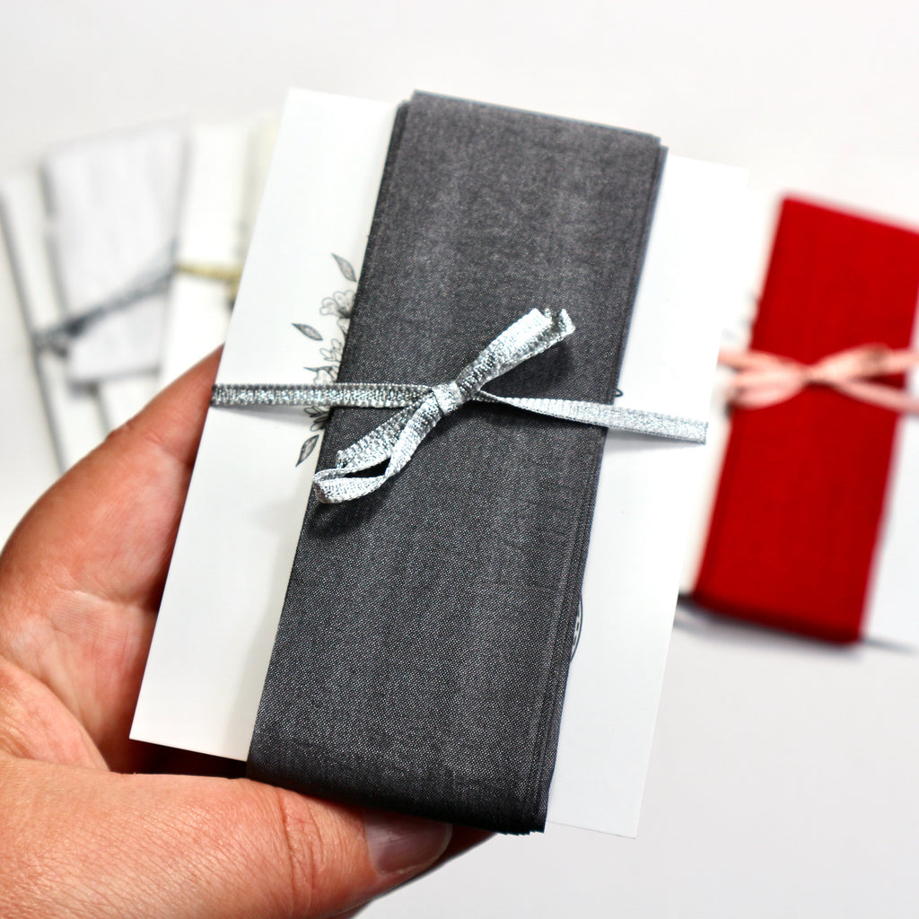 Slate grey faux silk ribbon on a display card.