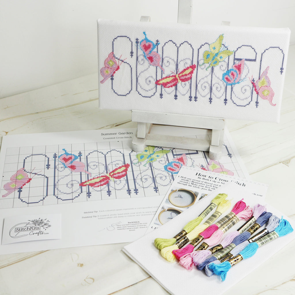 Summer garden, cross stitch on easel with kit content displayed.