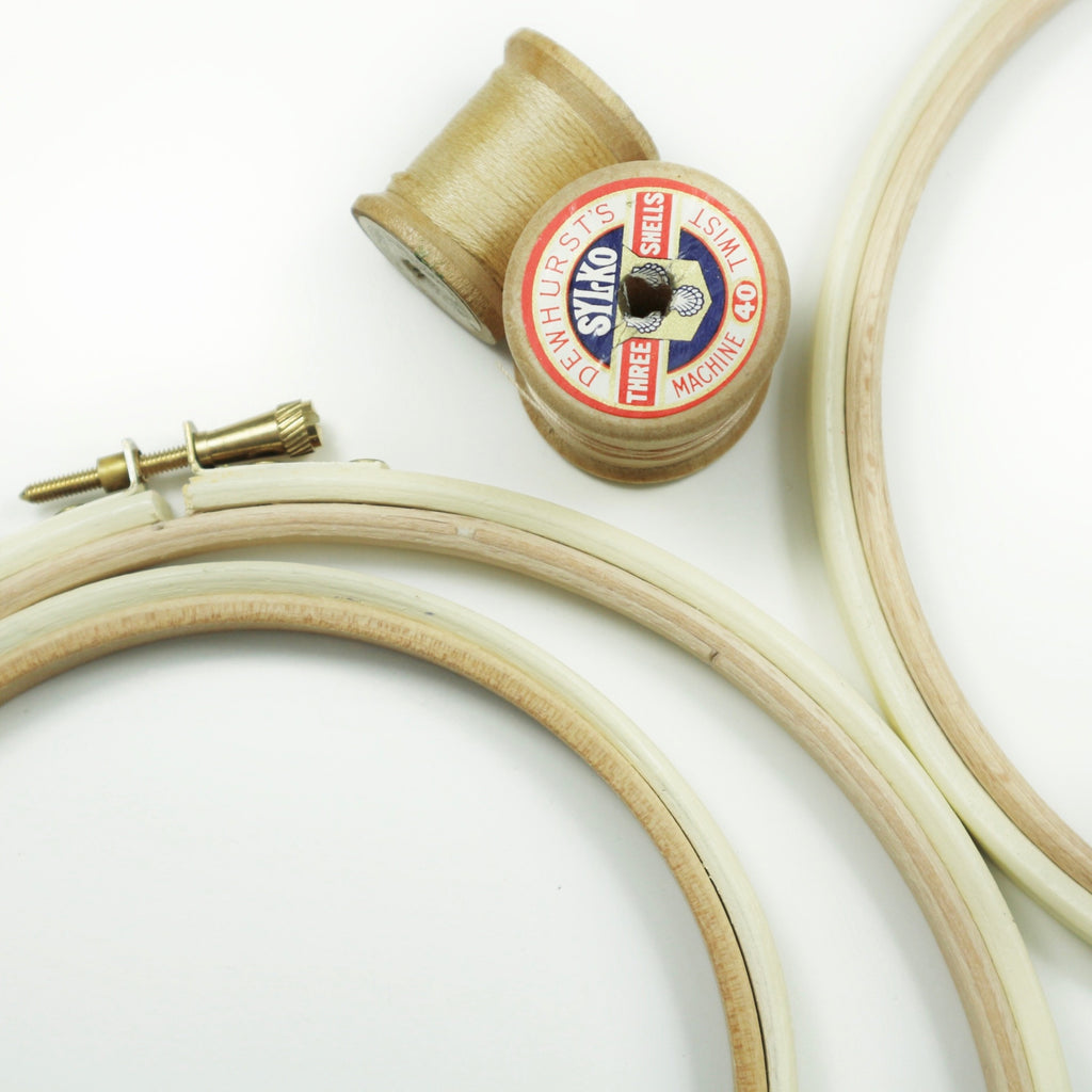 wooden embroidery hoops painted cream, with vintage cotton reels.