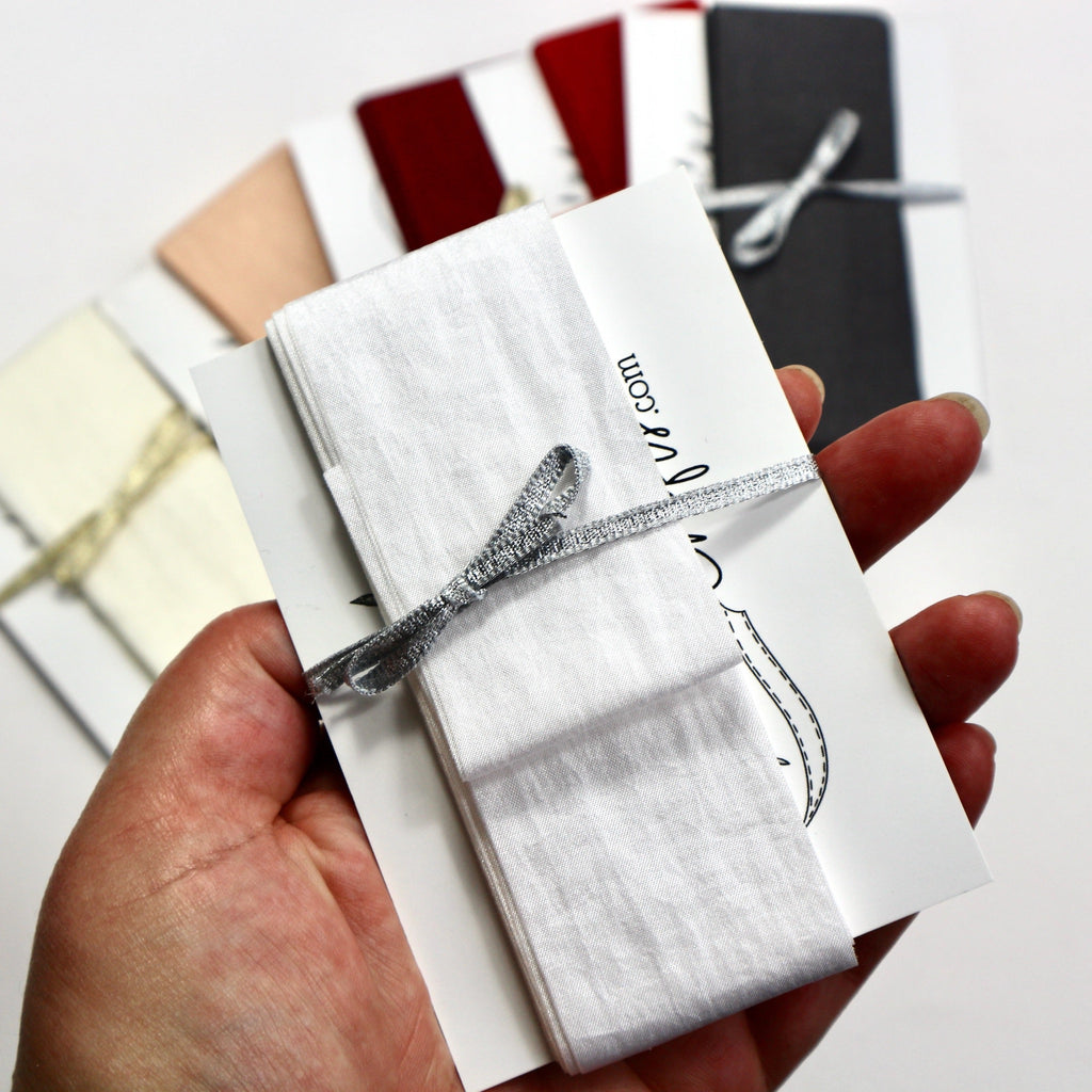 38mm wide White faux silk ribbon.