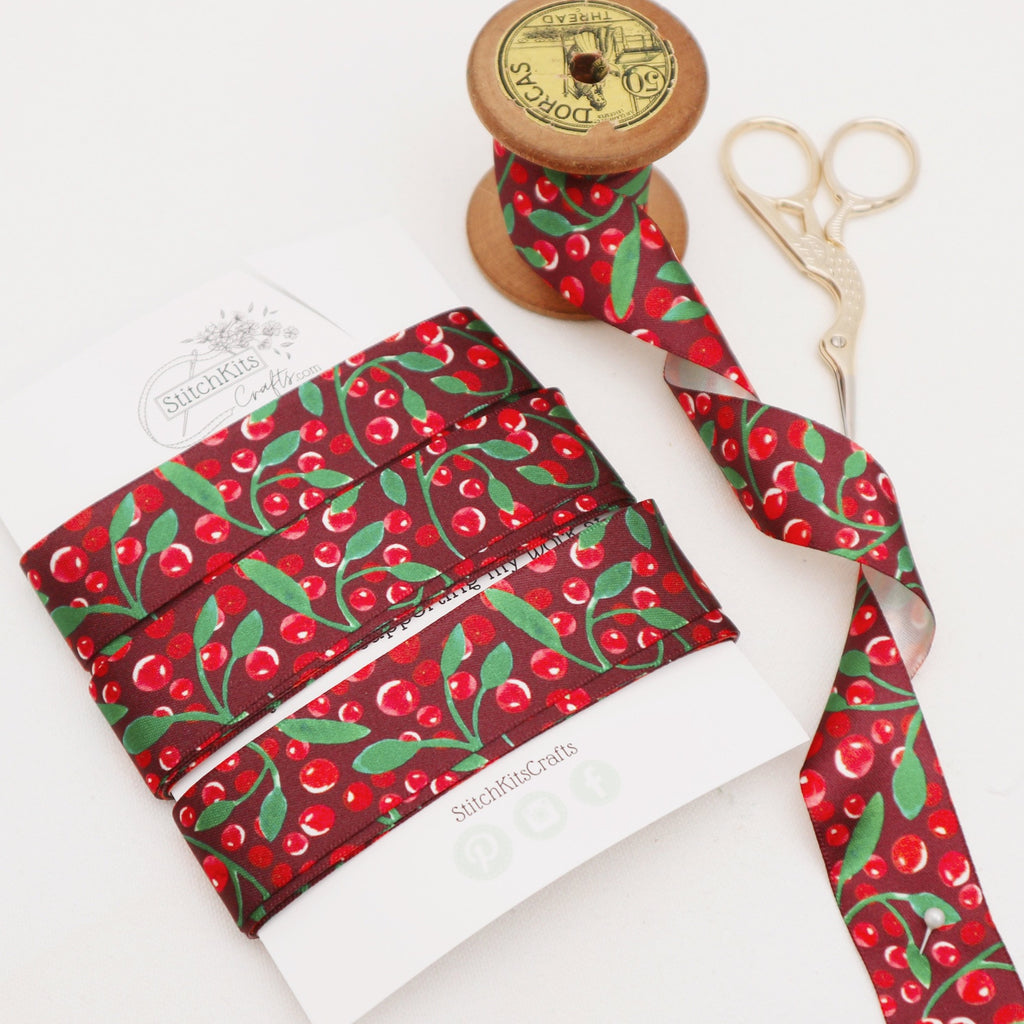 5 meters of deep red satin ribbon with a woodland berry design