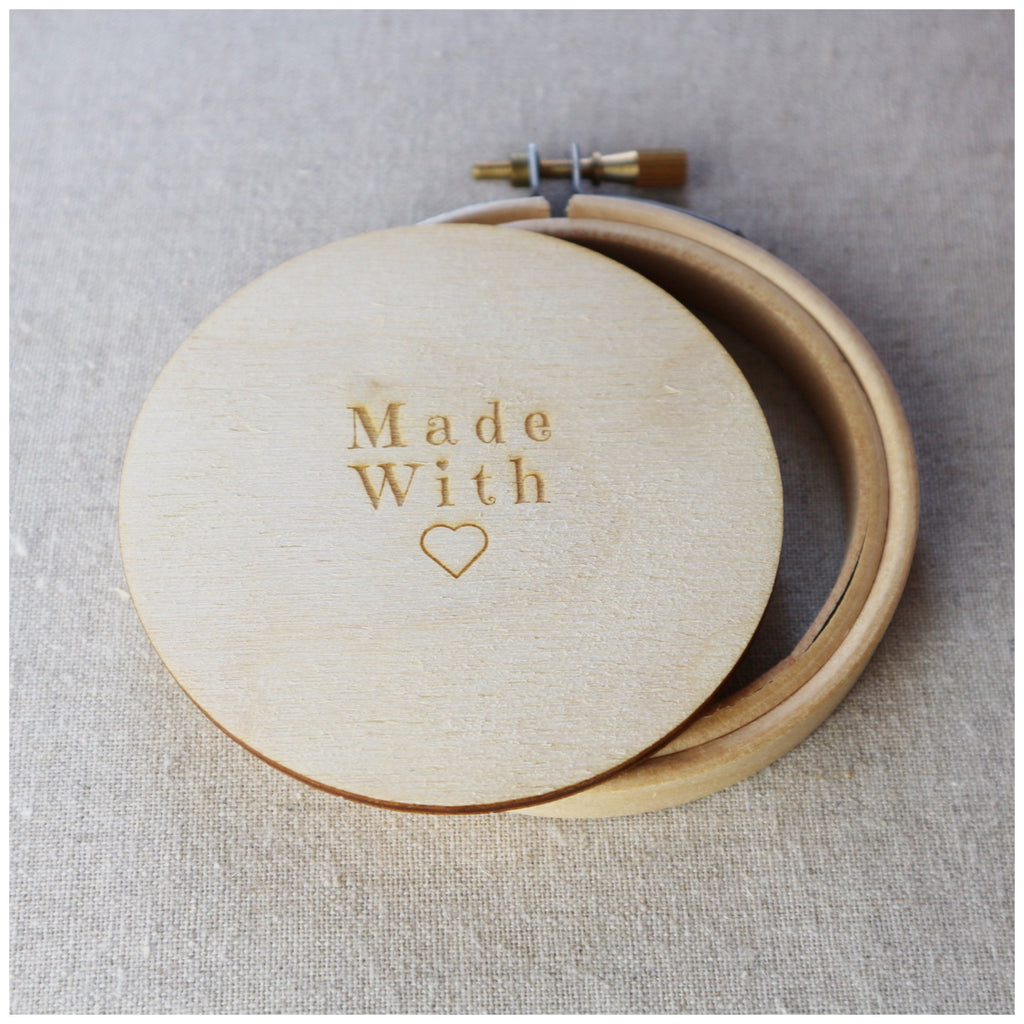Three inch embroidey hoop with wooden back for framing.