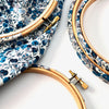 Two fabric-covered embroidery hoops with a blue and white Wiltshire Berry print, featuring wooden components and metal clasps.