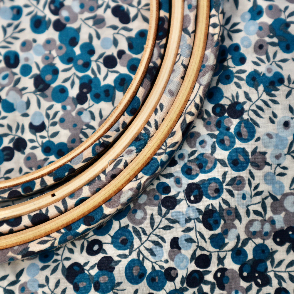 close up of blue wilthitre berry embroidery hoop for winter embroidery.