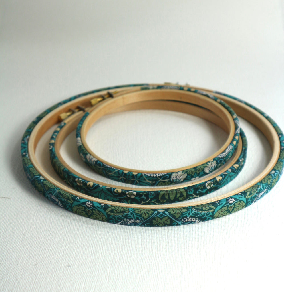 green wooden embroidery hoop wrapped in strawbery thief tana lawn cotton