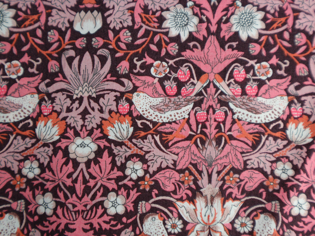 Pink 'Strawberry Thief' fabric was designed by William Morris, a name famous within the Arts and Crafts movement. 