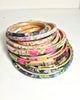 Stack of floral-patterned embroidery hoops on a white background