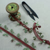 Oak leaf Christmas ribbon with red centre and satin green leaves.