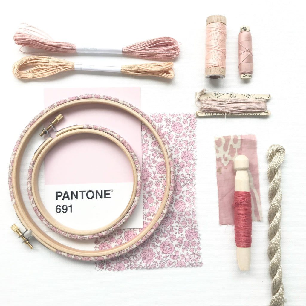 Pastel pink mood board with pink embroidery hoops and embroidery threads