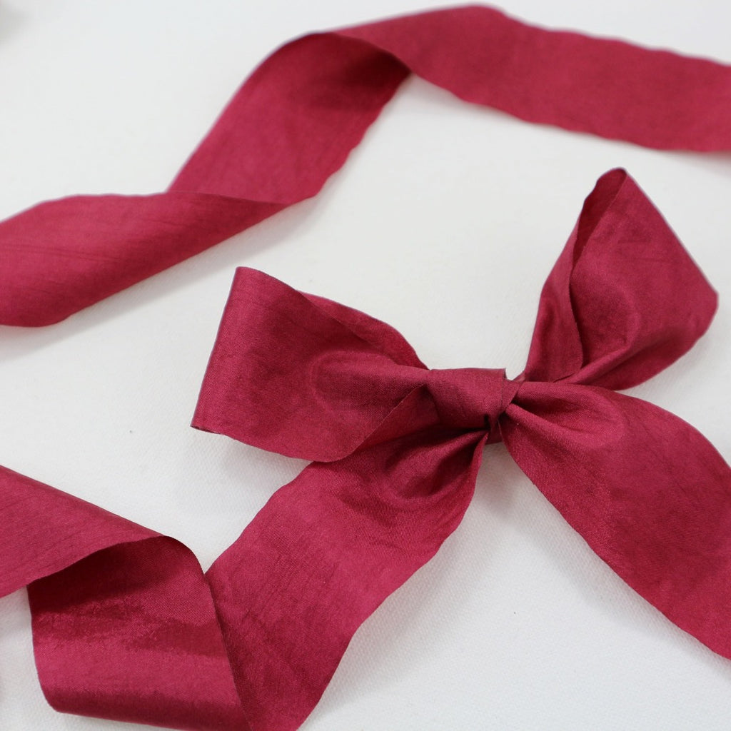 25 mm wide red faux silk ribbon bow.