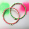neon pink and green embroidery hoops with spray paint