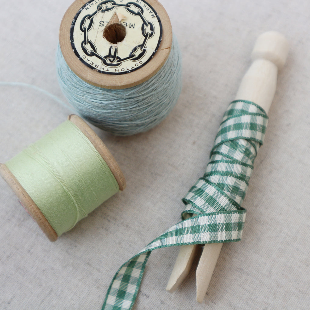 sage green gingham ribbon on wooden peg