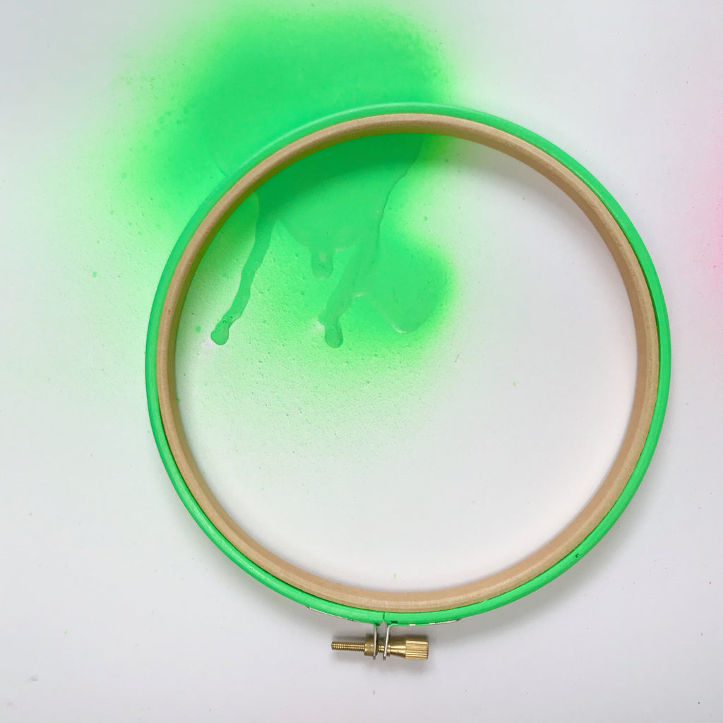 Neon green embroidery hoop with spray paint