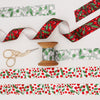 flat lay of winter berry christmas ribbon with vintage cotton reel and embroidery scissors.