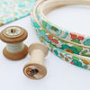 vintage cotton reels with blue green embroidery hoops
