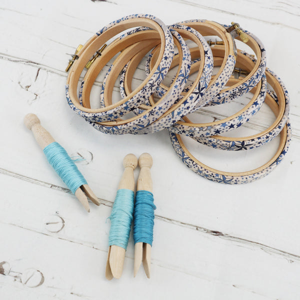 a pile of embroidery hoops covered in blue  star fabric, Adelaide tana lawn wraped embroidery hoops