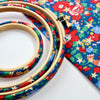 Embroidery hoops covered with christmas liberty fabric.