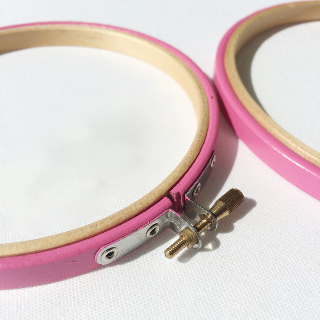 Two pink embroidery hoops. 