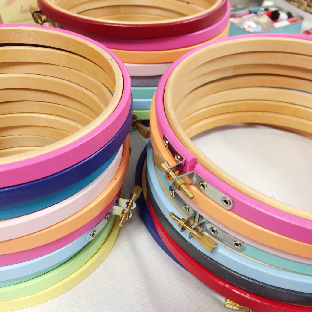 Stacks of brightly painted embroidery hoops