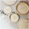 Wooden embroidery hoops with wooden backs and stork embroidery scissors.