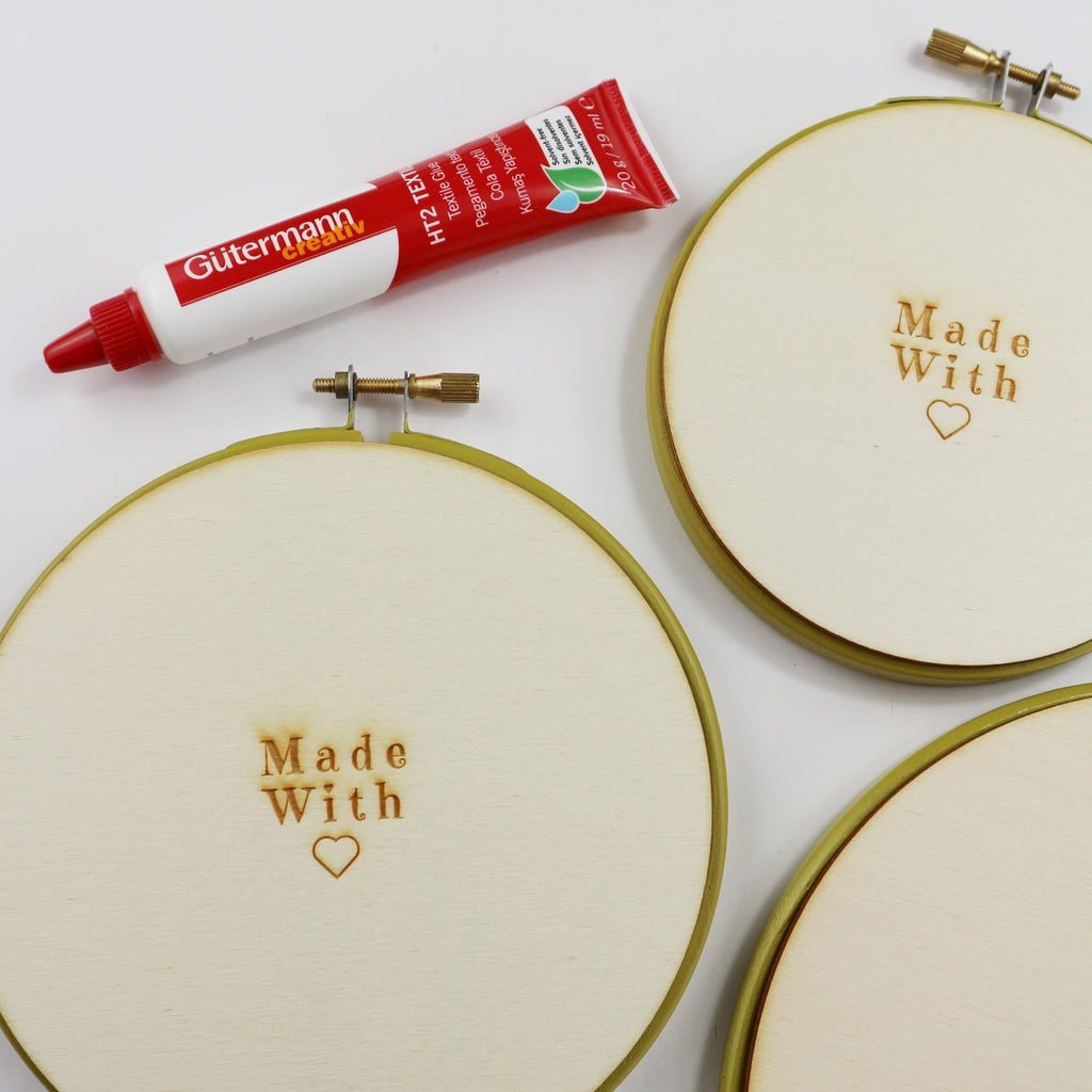 Embroidery hoops with wooden backs and textile glue.