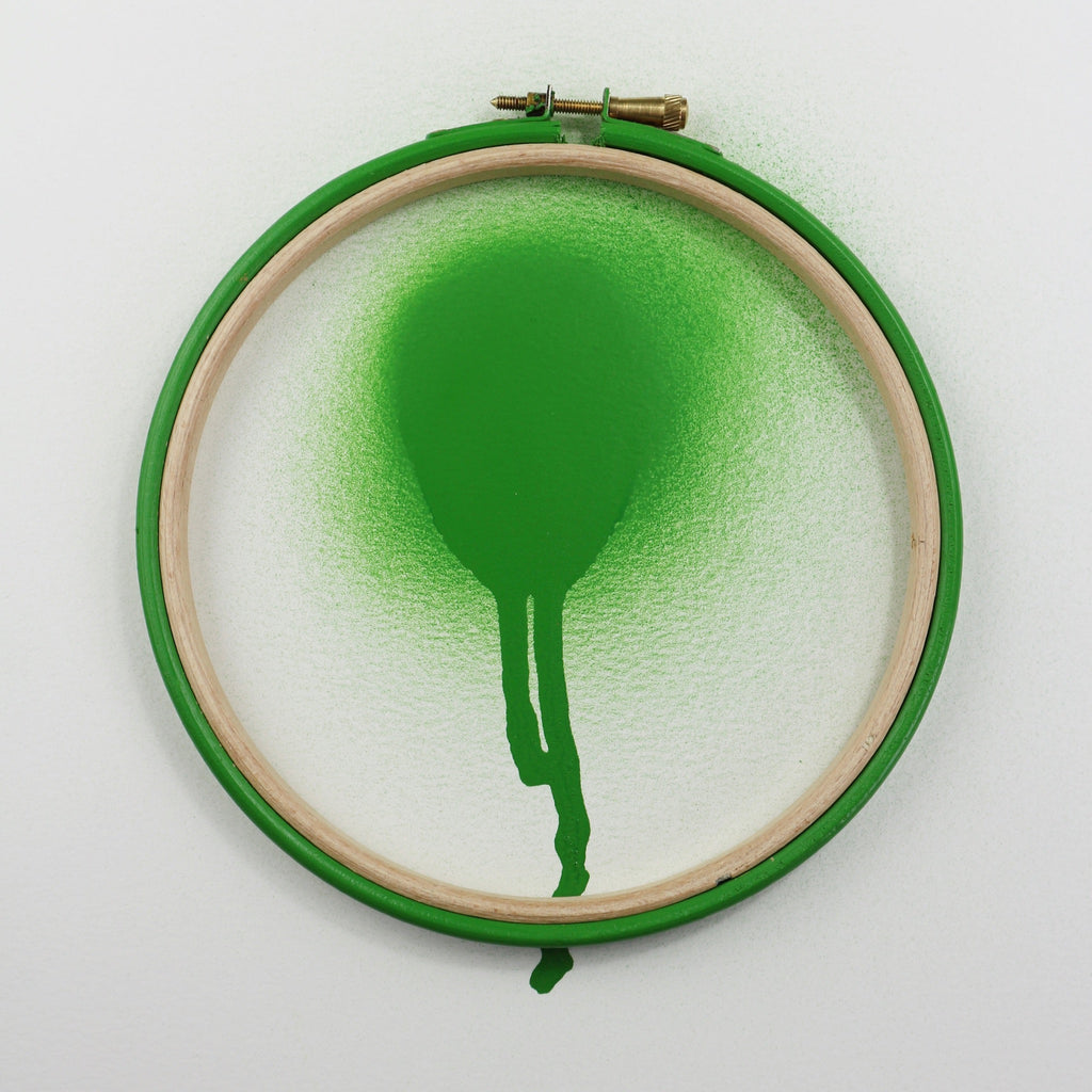 Bright green wooden embroidery hoop with green paint.