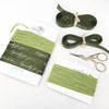 Green gift wrapping ribbon in different lengths.
