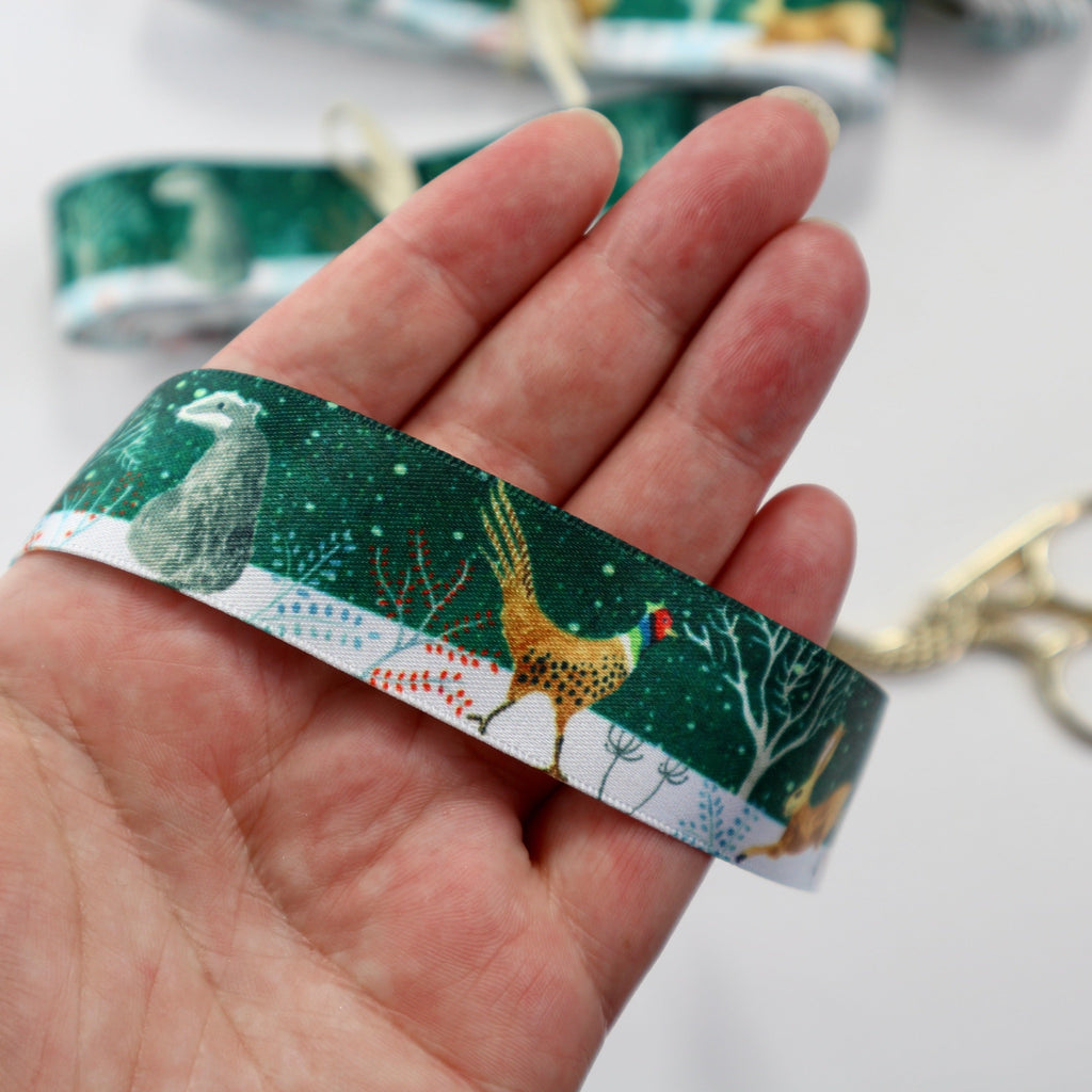 Ribbon with a forest snow scene featuring a badger, a partridge and a hare.