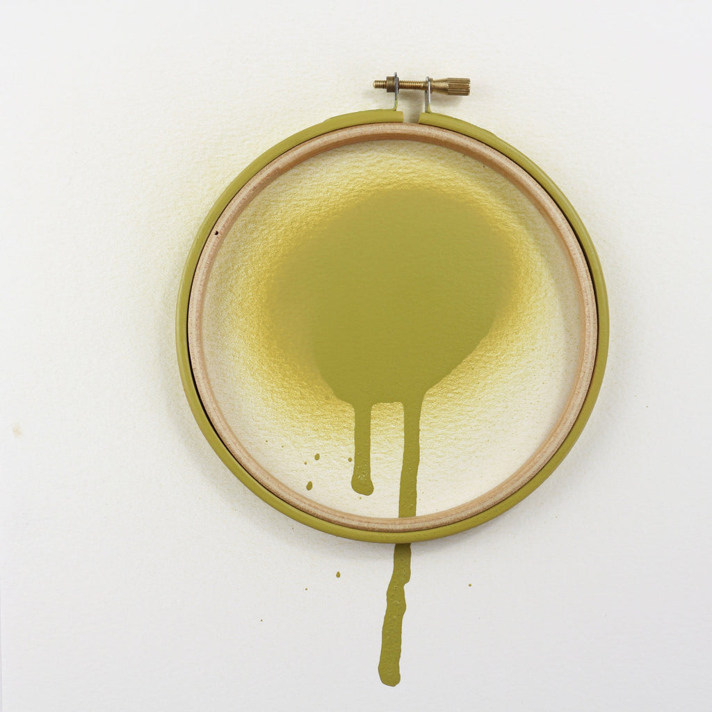 Khaki green embroidery hoop with spray paint.
