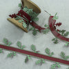 Christmas ribbon displayed on a vintage cotton reel.