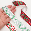 a collection of christmas gift wrapping ribbon with winter berry designs.