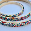 Embroidery hoops with colorful floral pattern on a white background