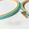 Coloured embroidery hoops painted turquoise.