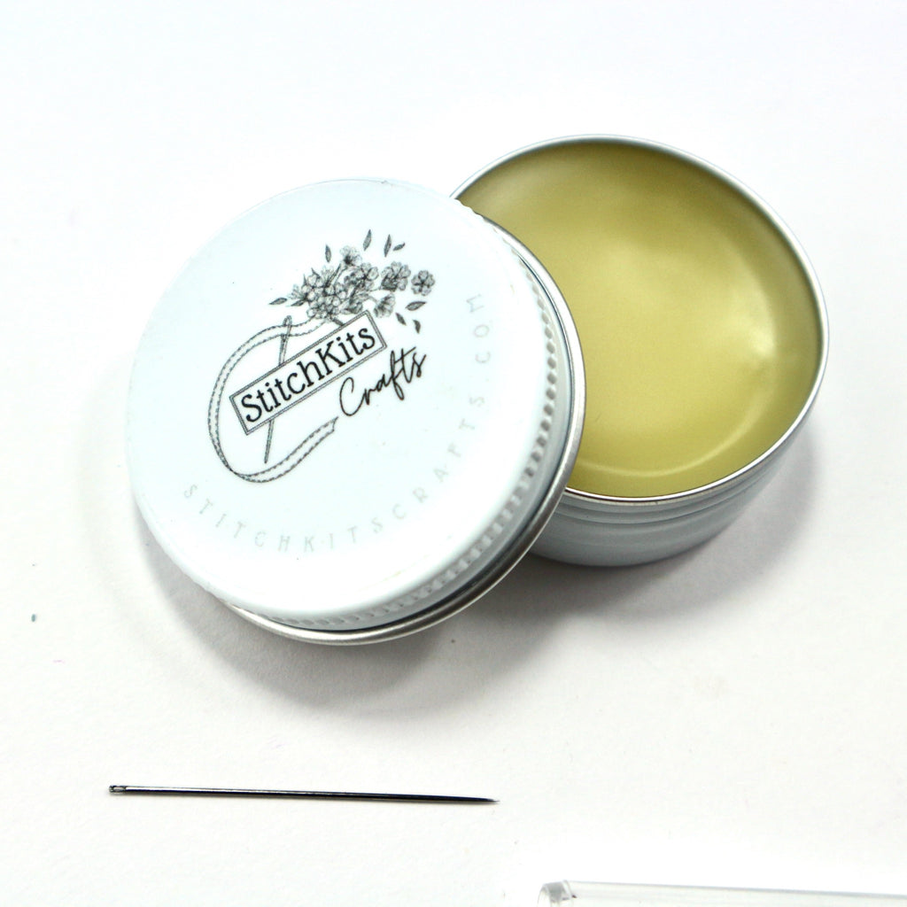 wax thread conditioner in a white tin